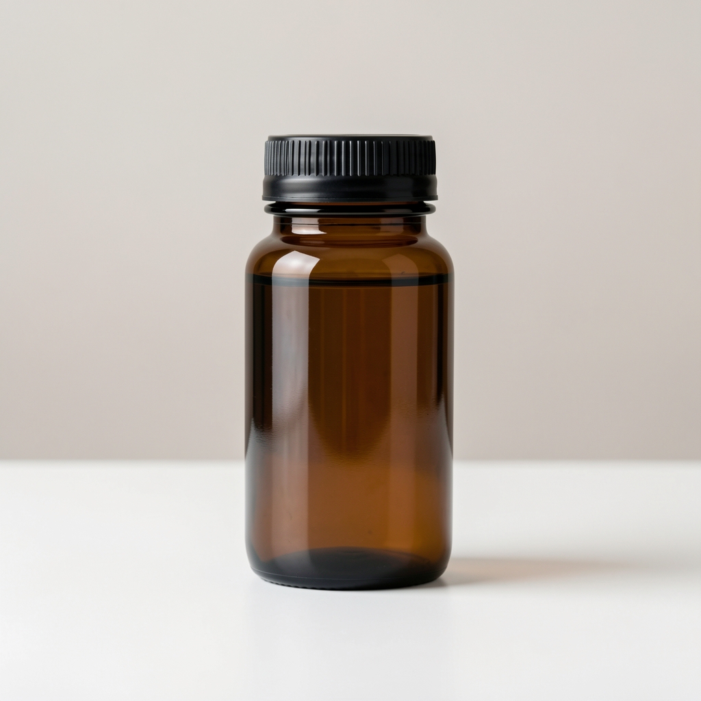 Dark amber vitamin bottle on clean white surface against soft neutral background, editorial supplement photograph